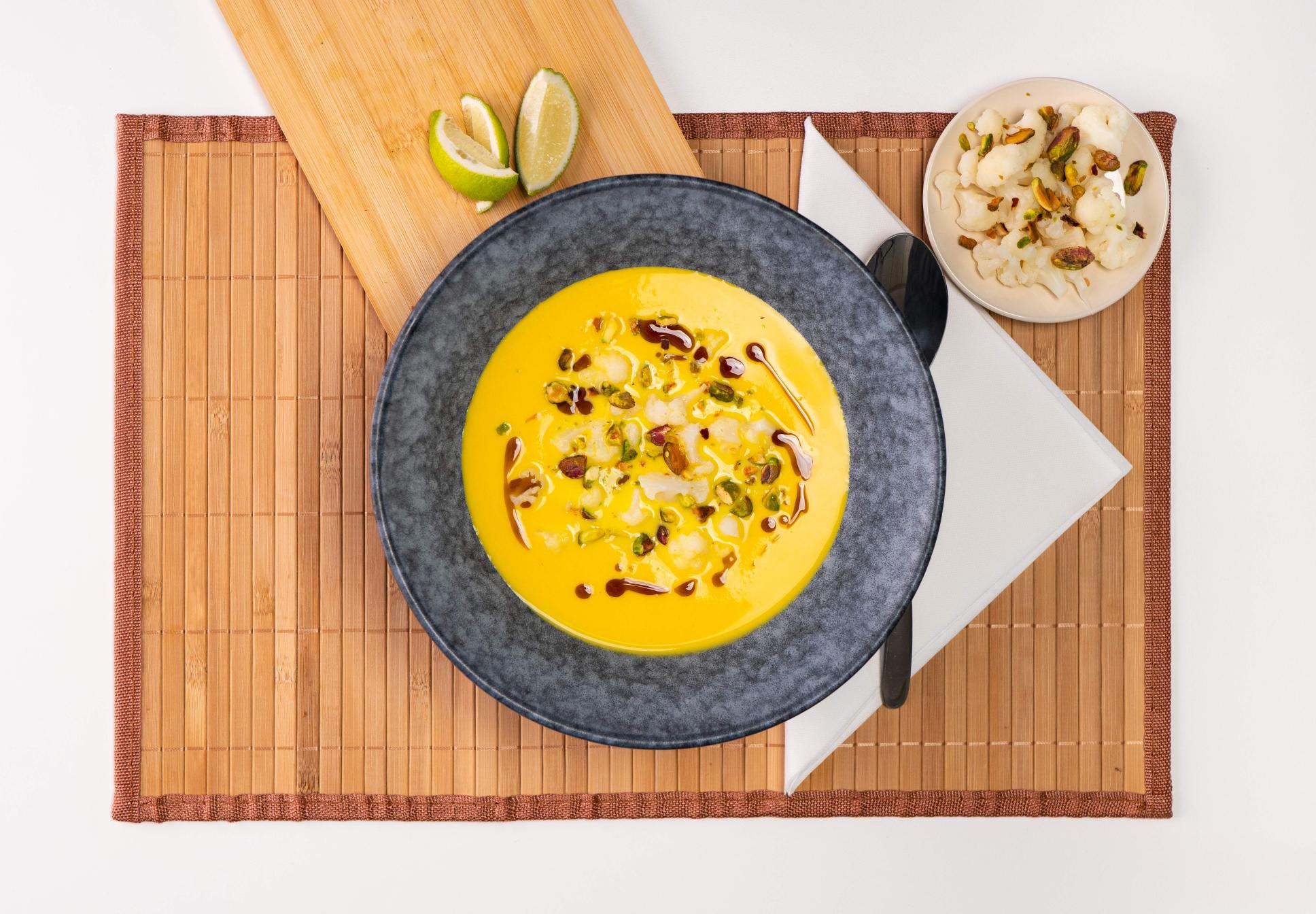 Soft turmeric cauliflower cream soup with toasted pumpkin seed oil - Eisberg